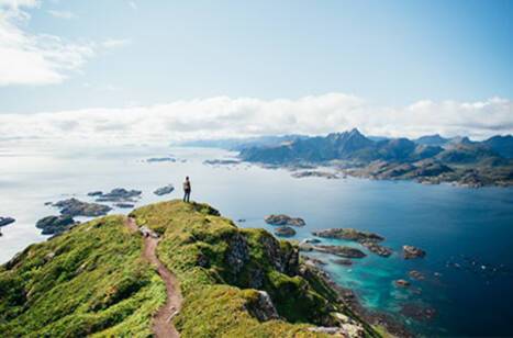 Person looking out over Norway’s landscapes