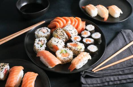 Three plates of sushi with chopsticks
