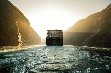 Queen Elizabeth sailing through a Norwegian fjord