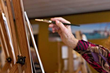 A person painting on an easel
