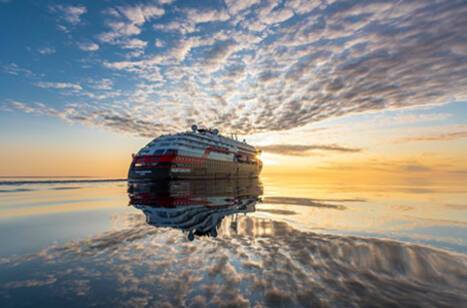 MS Roald Amundsen sailing into the sunset