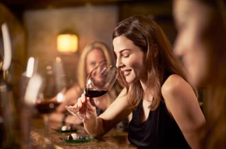 A woman enjoying a glass of wine in Vines Bar on a Princess Cruises voyage