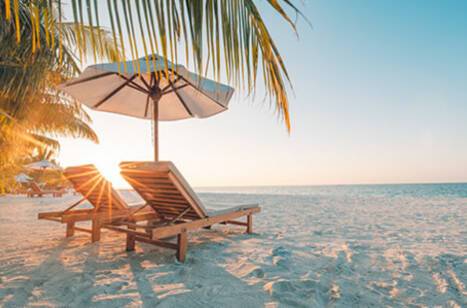 Two deck chairs on a picturesque Caribbean beach