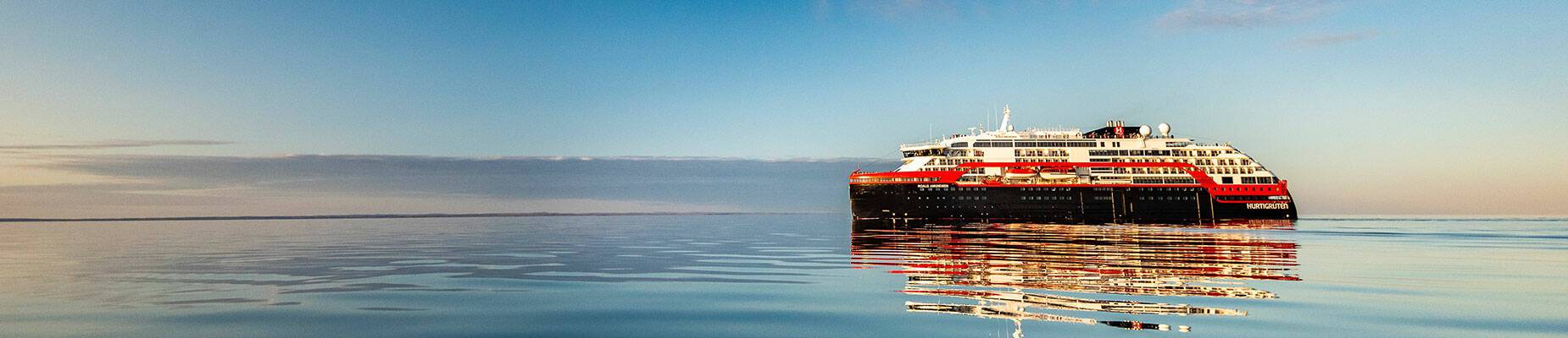 A cruise ship at sea during sunrise