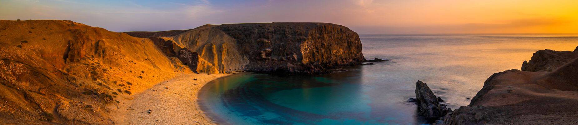 Panoramic image of Lanzarote beach at sunset