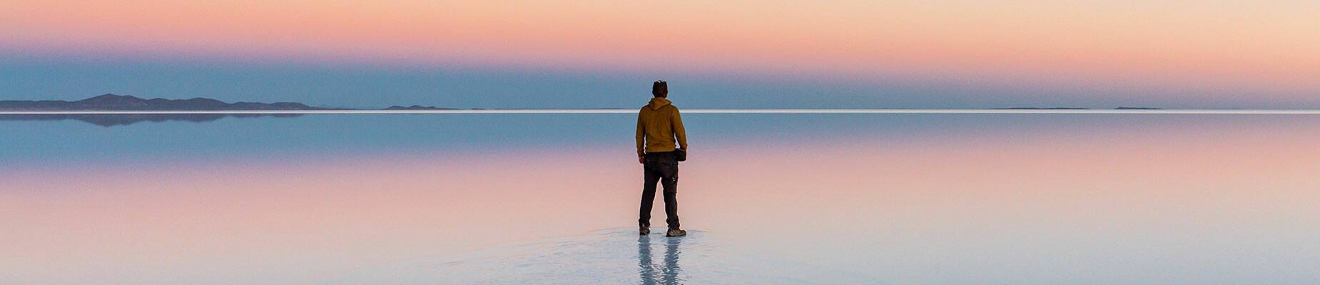 A lone man standing on a beach