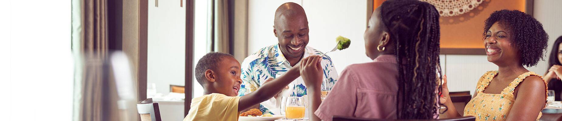 A family of four sitting together at a dinner table