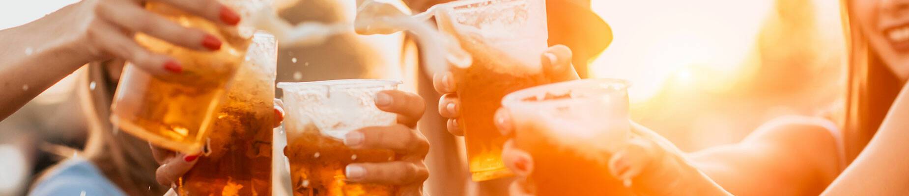 A group of people cheersing with beer