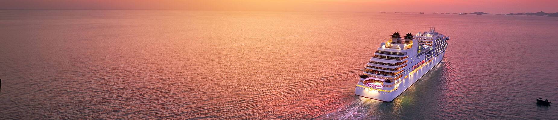 A cruise ship setting sail for sunset