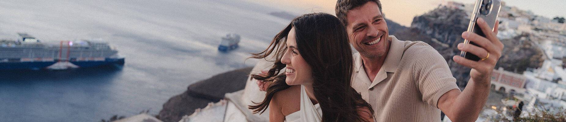 A couple taking a photo in front of Celebrity Ascent