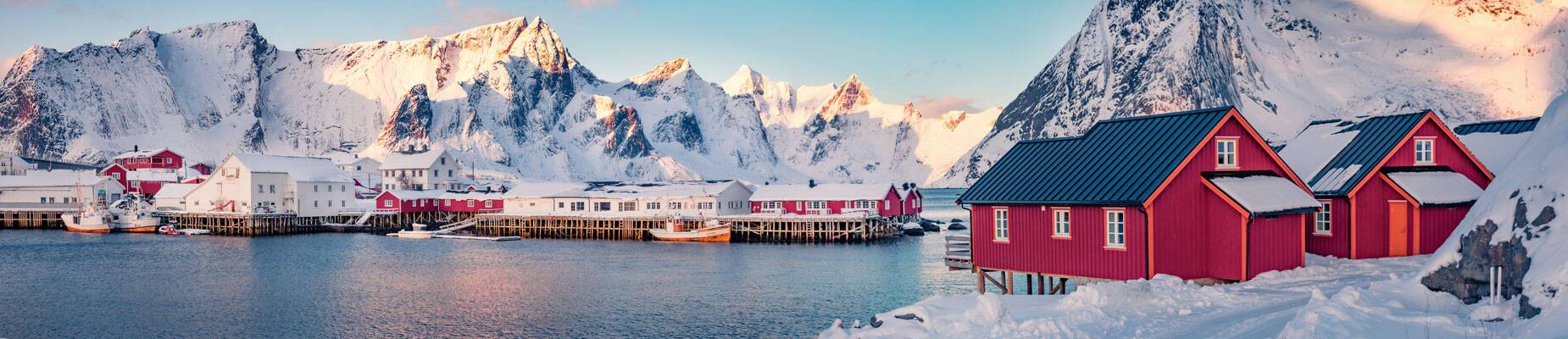 Panoramic image of a small, snow-covered fishing town in Norway