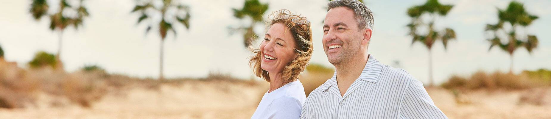 A couple walking along a beach in the Caribbean