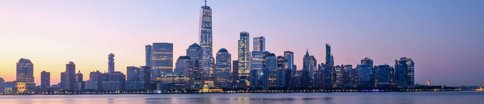 A panoramic image of the New York skyline at sunset
