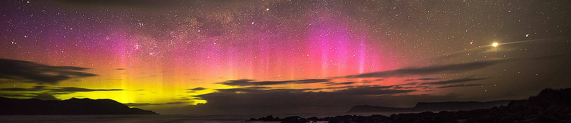 The Southern Lights dancing in the sky in Cloudy Bay, Tasmania