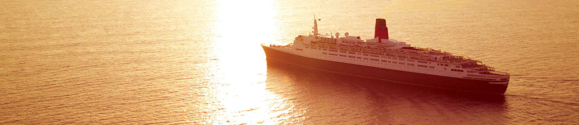 Panoramic image of Queen Elizabeth 2 at sea during sunset