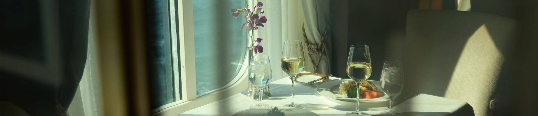 A table by a window on a cruise ship