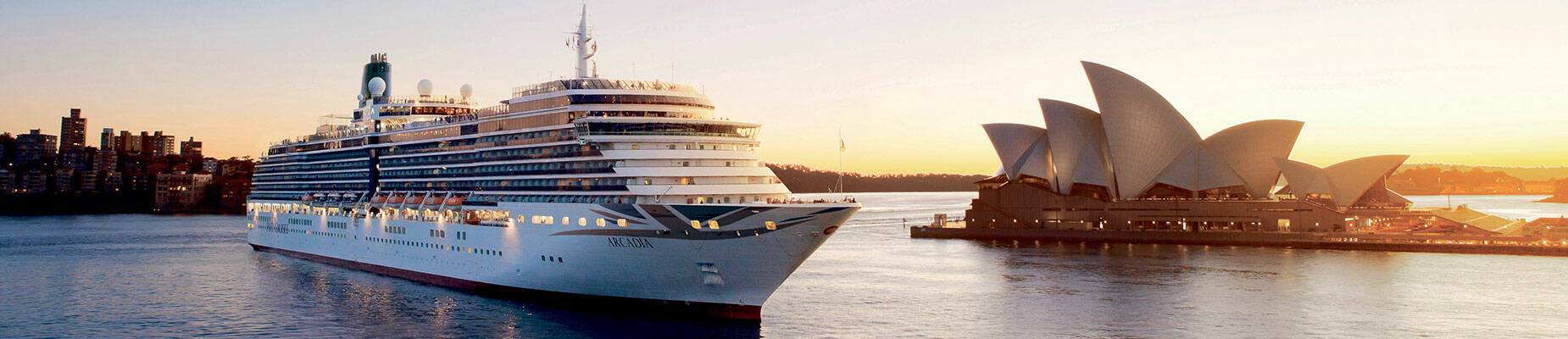 A cruise ship leaving Sydney Harbour at sunset