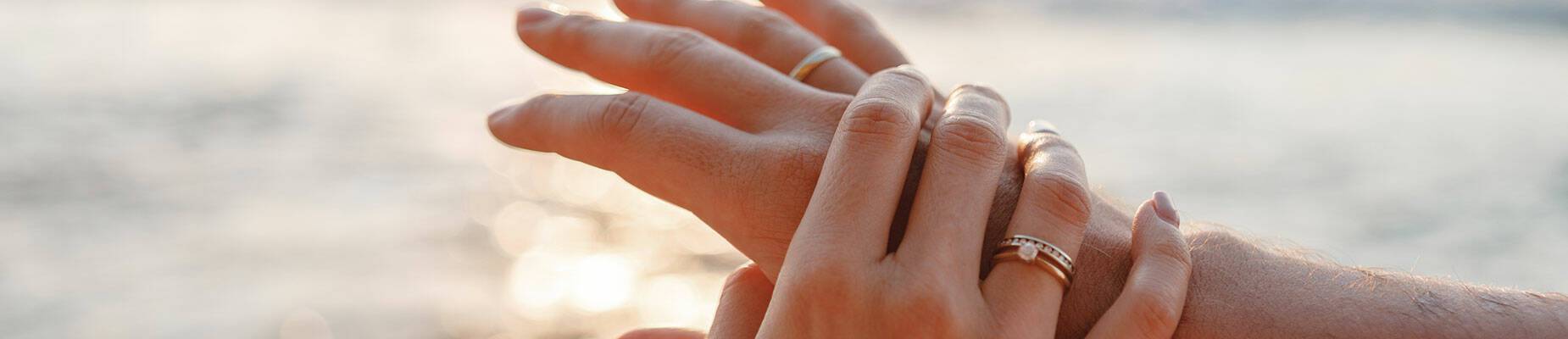 Two hands with wedding rings