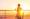 A woman admiring the sunset on a cruise ship
