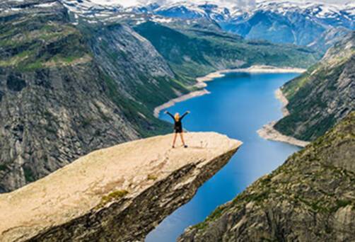 Girl standing on Trolltunga in Stavanger