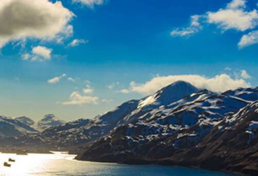 A panoramic view of boats passing through Dutch Harbor