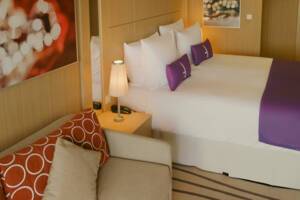 Premium Suite Bedroom & Living Area, Ambition, Ambassador Cruise Line