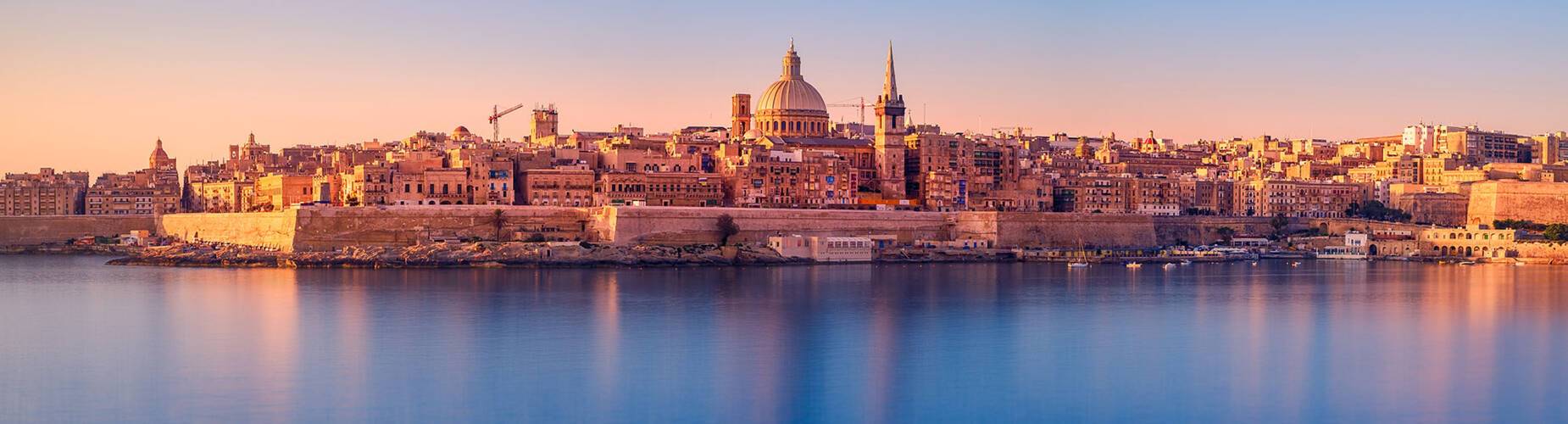 The sun rising over Valletta