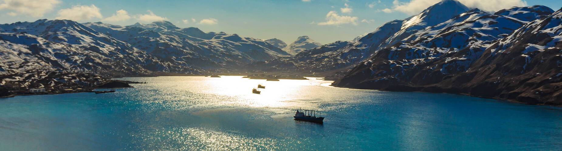 A panoramic view of boats passing through Dutch Harbor