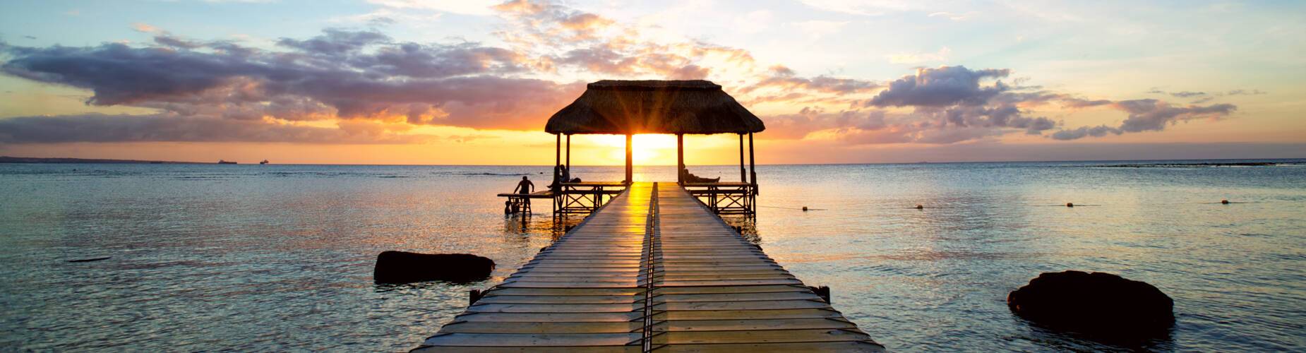 Jetty silhouette against beautiful sunset in Mauritius Island